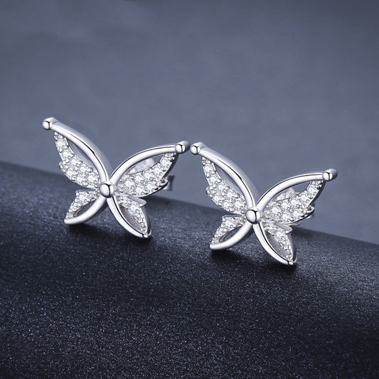 Butterfly studs on dark background displaying rhinestone sparkle and silver finish
