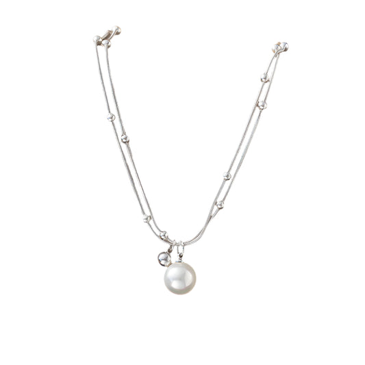 A silver-tone double chain pearl necklace with geometric pendants on a white background.