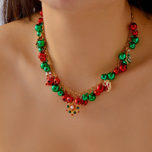 Necklace with red and green beads on a plain background