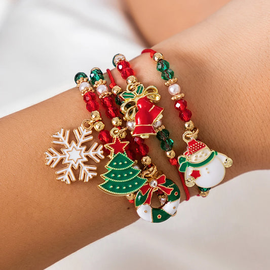 Christmas-themed bracelet with snowflake, tree, and Santa Claus charms on a wrist.