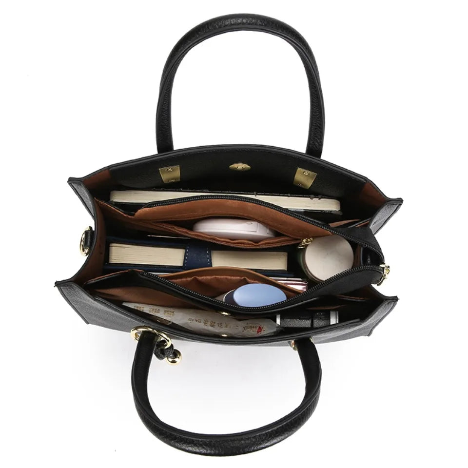 Black handbag with open compartments on a white background