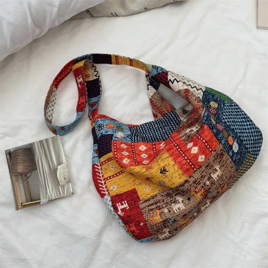 Colorful patchwork bag on a white bedspread