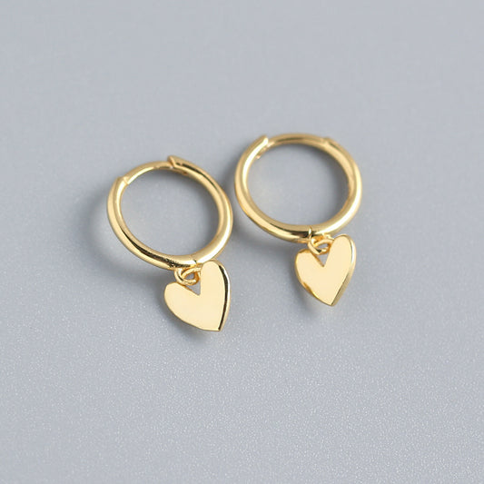 Detail view of heart-shaped gold plated earrings with electroplating finish