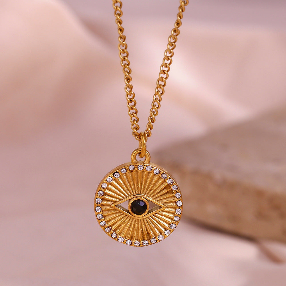 Minimalist gold coin necklace with black eye rhinestone and rising sun design on stainless steel chain