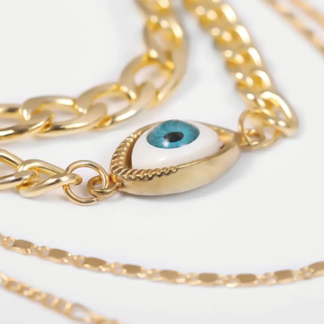 Zoomed detail of evil eye pendant on gold chains