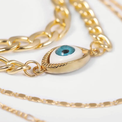 Zoomed detail of evil eye pendant on gold chains