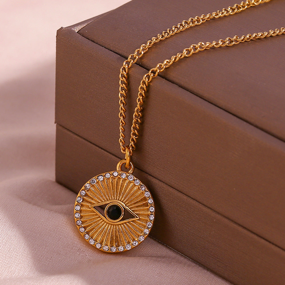 Minimalist gold coin necklace with black eye rhinestone and rising sun design on stainless steel chain