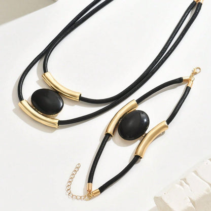 Necklace with black stones and gold accents on a white background