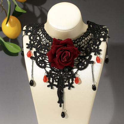Black lace collar with red rose and beads on a mannequin bust.