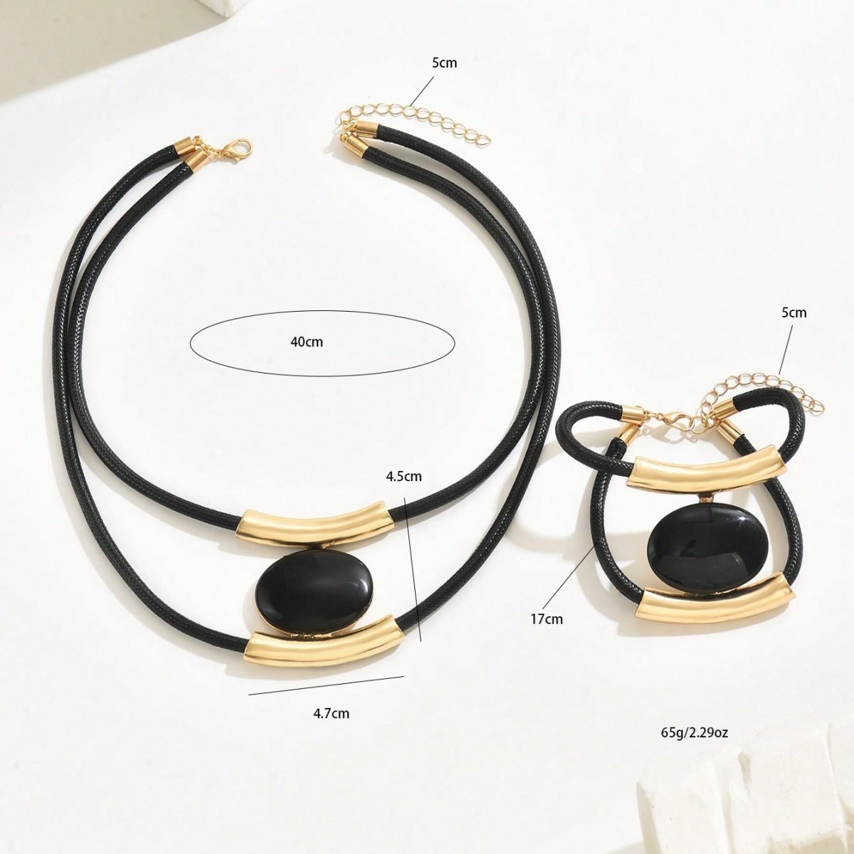 Black and gold necklace with measurements on a white background