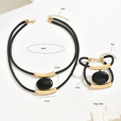 Black and gold necklace with measurements on a white background