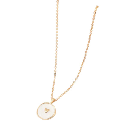 Gold necklace with a heart pendant on a white surface
