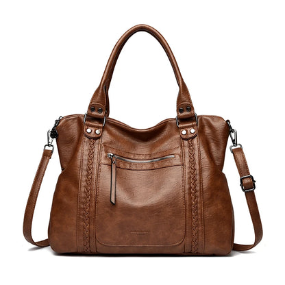 Brown leather handbag with a shoulder strap on a white background