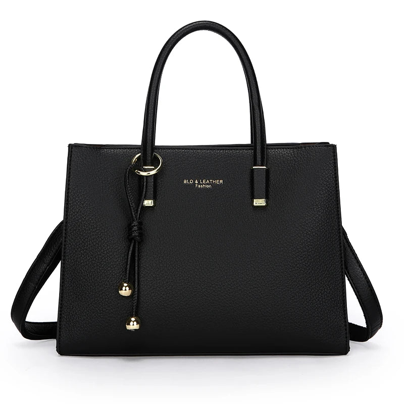 Black handbag with gold accents on a white background