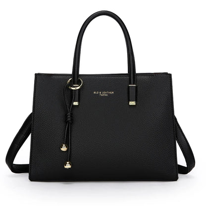 Black handbag with gold accents on a white background