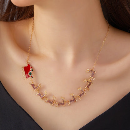 Gold necklace with a red pendant on a mannequin