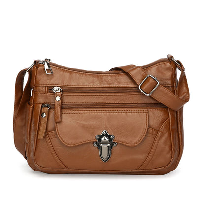 Brown leather handbag with silver buckle on a white background