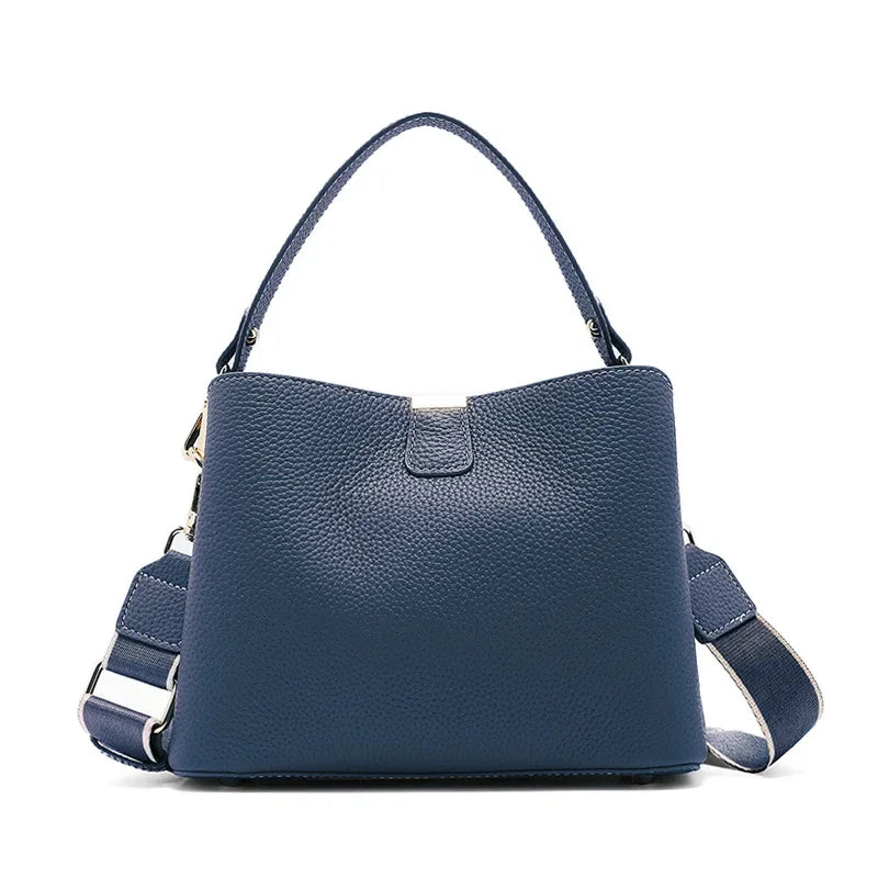 Blue handbag with a shoulder strap on a white background