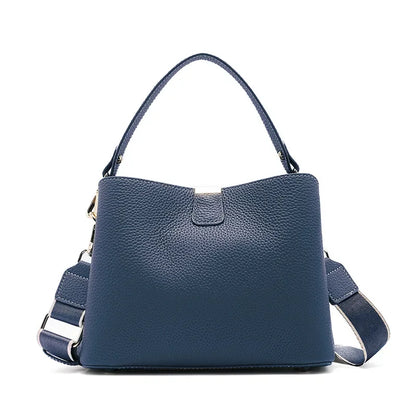 Blue handbag with a shoulder strap on a white background