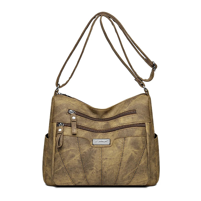 Brown leather handbag with multiple pockets and a strap on a white background