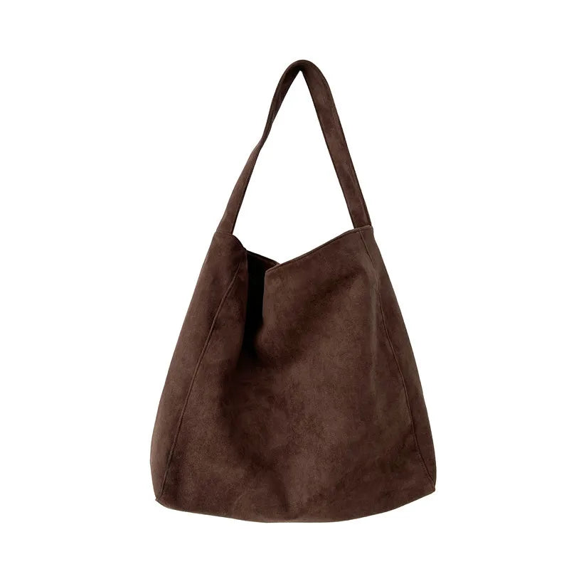 Brown suede handbag on a white background