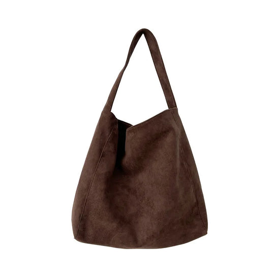 Brown suede handbag on a white background