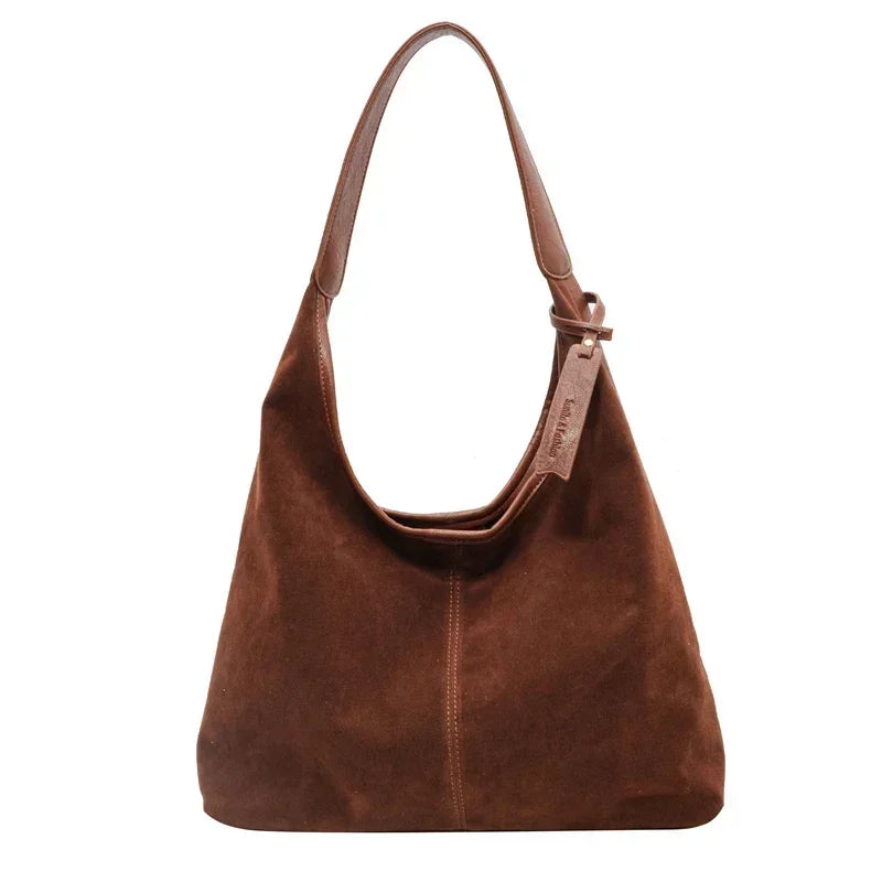 Reddish Brown leather handbag on a white background