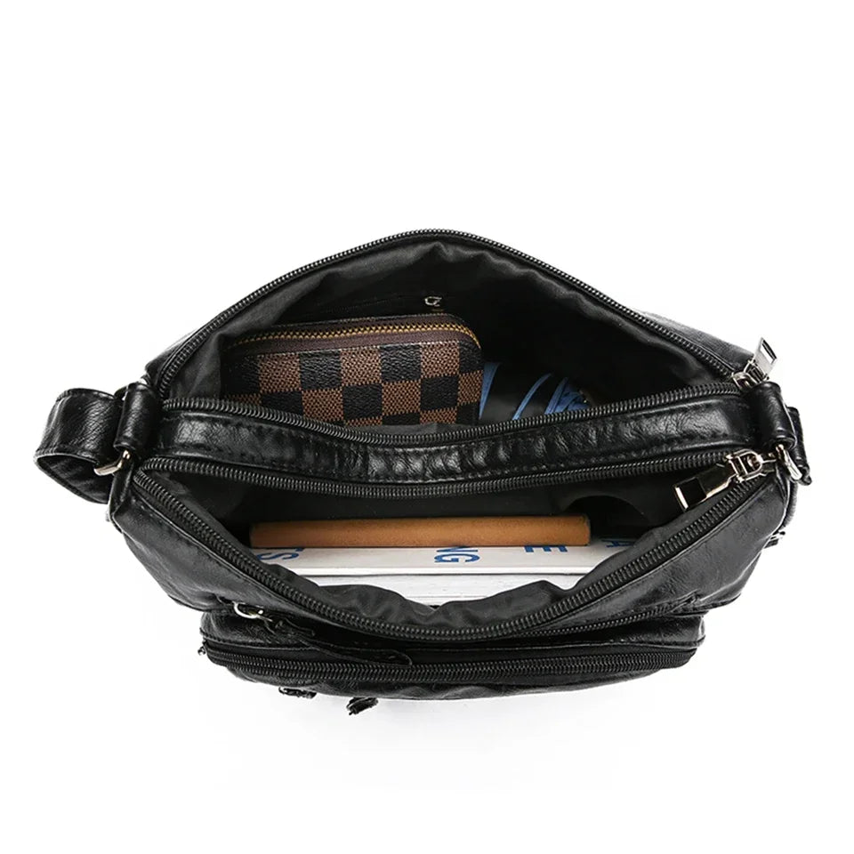 Black leather bag with a checkered pouch inside on a white background