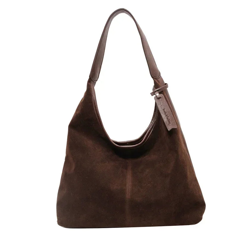 Coffee Brown handbag with a visible brand tag on a white background