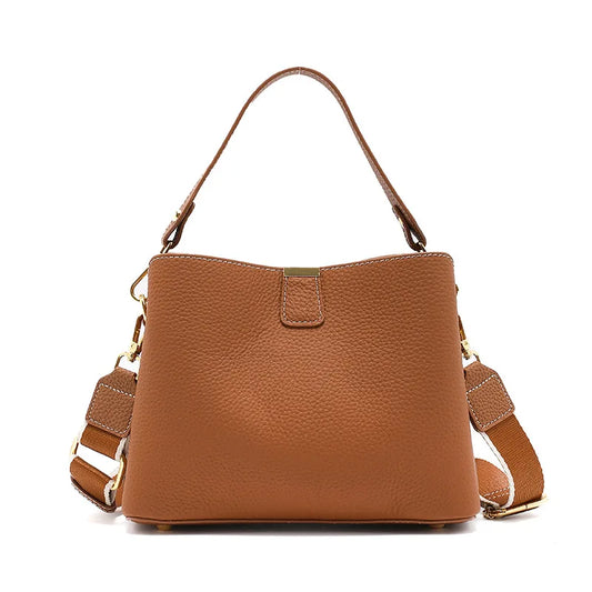 Brown leather handbag with shoulder strap on a white background