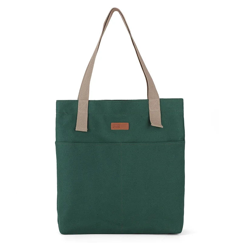 Green tote bag with beige straps on a white background