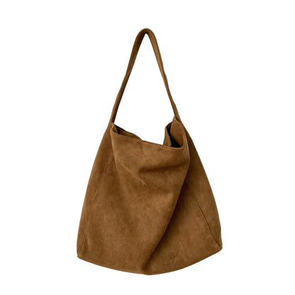 Brown suede handbag on a white background