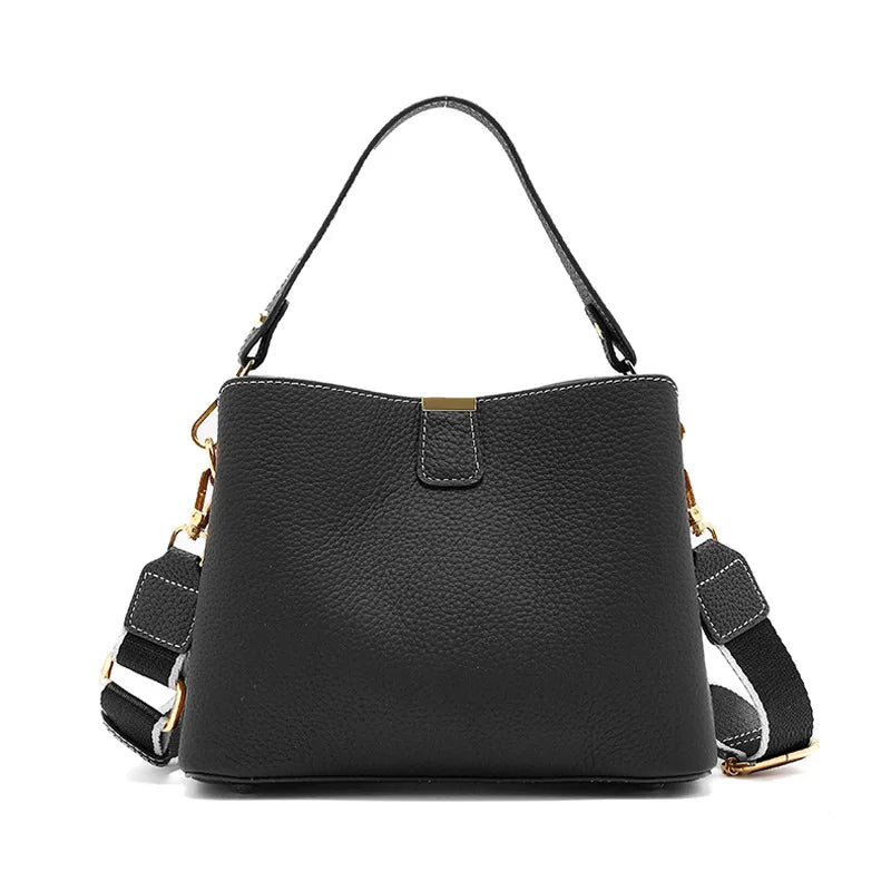 Black handbag with a strap on a white background