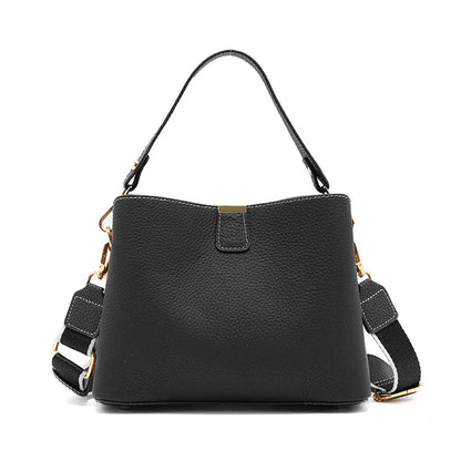 Black handbag with a strap on a white background