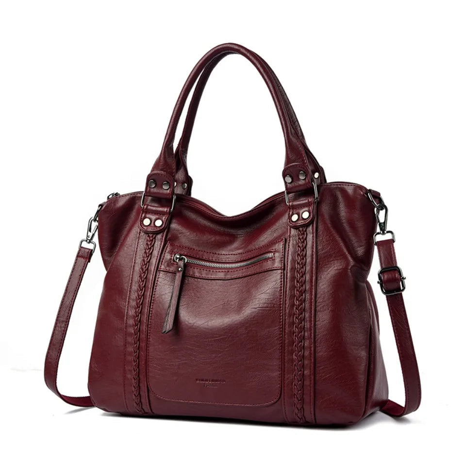 Brown handbag with a shoulder strap on a white background. MYH