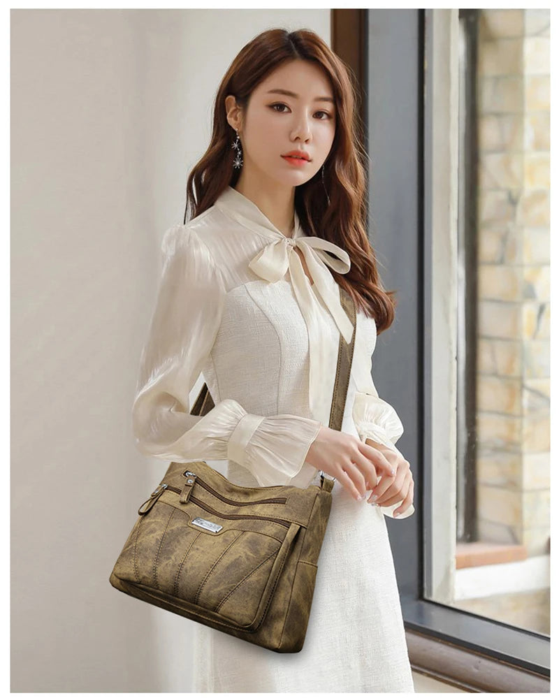 Woman holding a brown handbag indoors