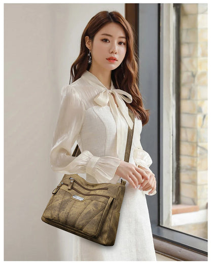 Woman holding a brown handbag indoors