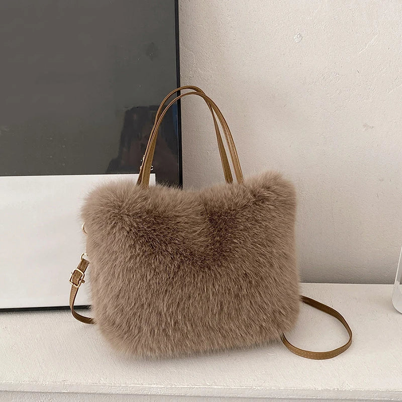 Fluffy brown handbag with a strap on a white surface.