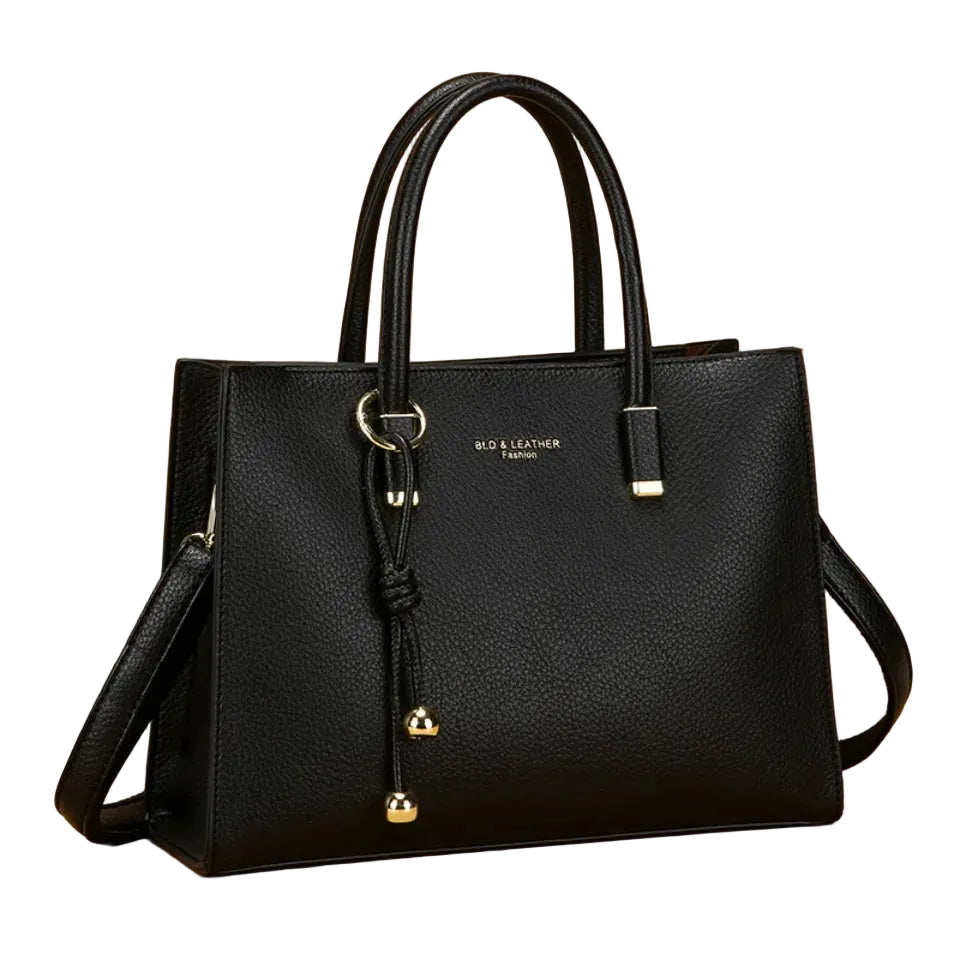 Black handbag with gold accents on a beige background, featuring the brand 'Vanderwah'.