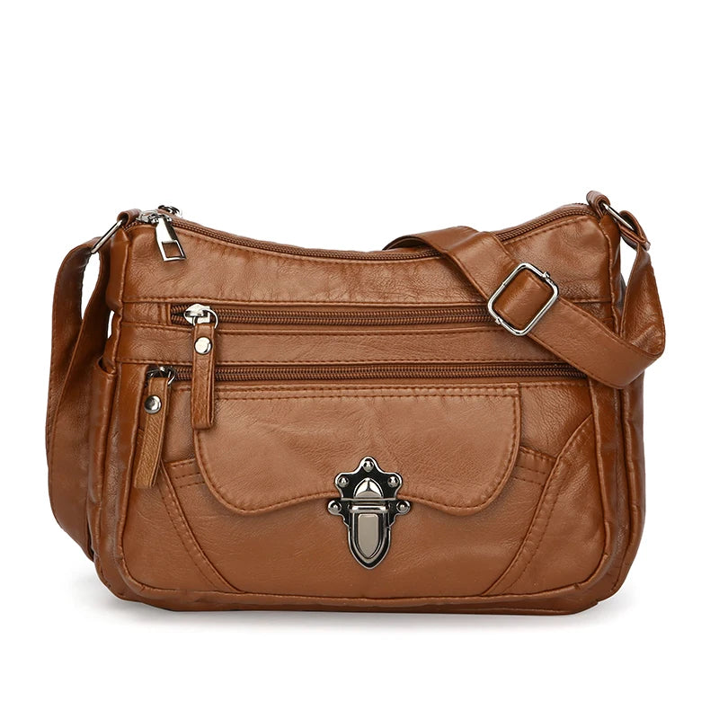 Brown leather handbag with silver buckle on a white background