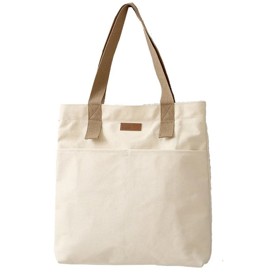 Beige tote bag with brown handles on a white background