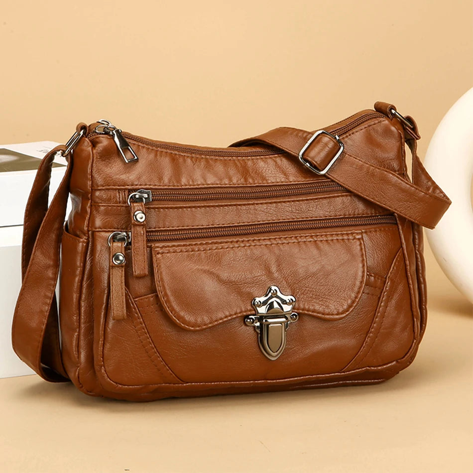 Brown leather handbag with silver hardware on a beige background