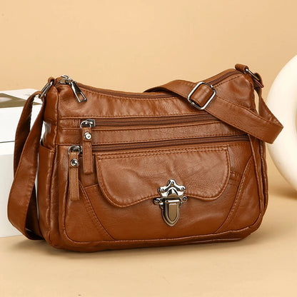 Brown leather handbag with silver hardware on a beige background