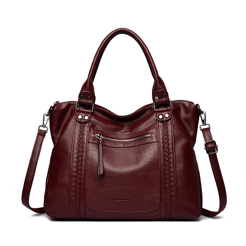 Brown leather handbag with multiple pockets and straps on a white background