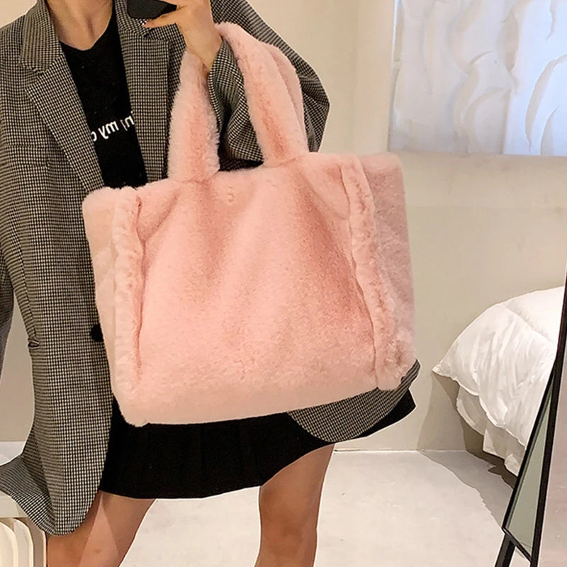 Person holding a fluffy pink handbag in a room with a bed in the background