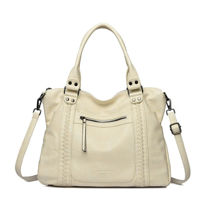 Beige handbag with braided details on a white background