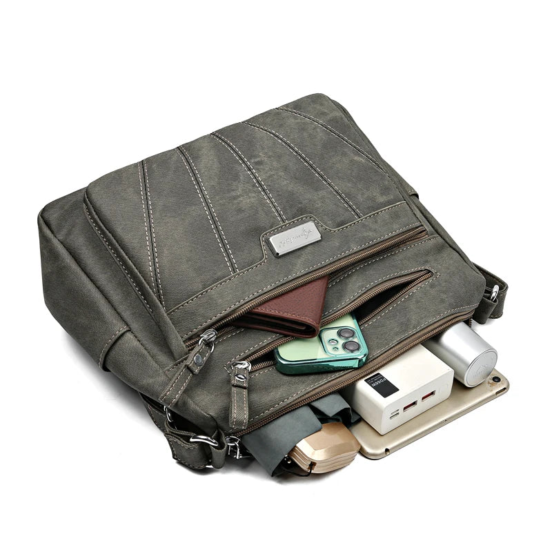 Gray backpack with various items inside on a white background