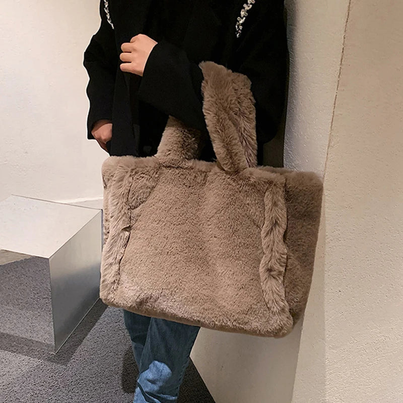 Person holding a fluffy brown tote bag in an indoor setting
