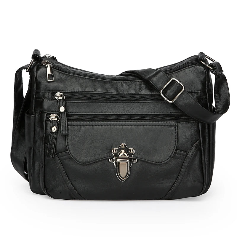 Black handbag with multiple pockets and a decorative clasp on a white background