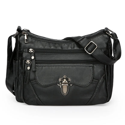 Black handbag with multiple pockets and a decorative clasp on a white background